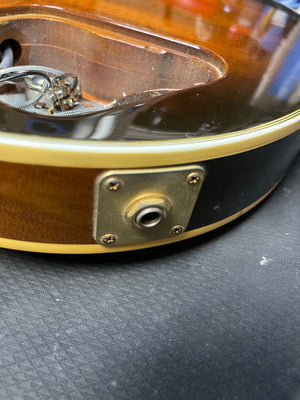 Close-up of a 1980 Gibson Les Paul Custom – Tobacco Sunburst, showing the output jack and internal wiring cavity with visible components.