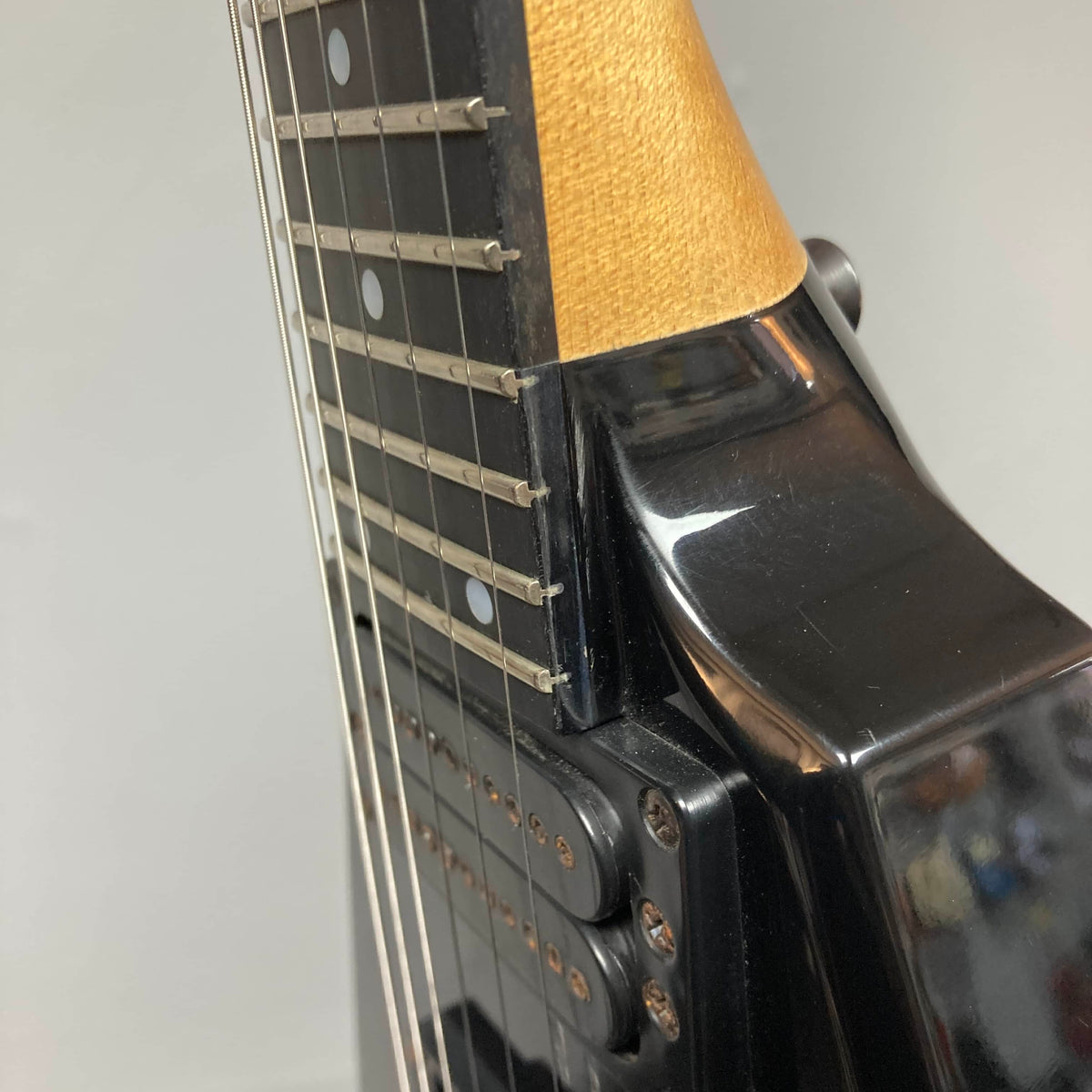 Close-up view of a Carvin 1992 Ultra V USA electric guitar neck and body, featuring strings, frets, and pickups with a Kahler Steeler Trem and MJ-wound Seymour Duncan DCJ.