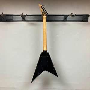 A 1992 Carvin Ultra V USA with Kahler Steeler Trem and MJ-wound Seymour Duncan DCJ pickups hangs by its headstock on a wall-mounted rack, showcasing the sleek back.