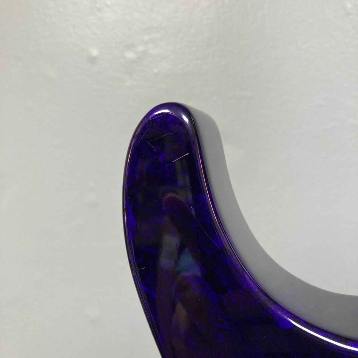 Close-up of the upper horn of a Jackson 1995 SL1 Soloist Custom Shop electric guitar in Eerie Dess Swirl finish, set against a plain light gray wall.