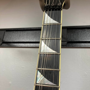 Close-up of the neck of a 1995 Jackson SL1 Soloist Custom Shop Eerie Dess Swirl guitar, highlighting four frets and prominent triangular pearl inlays on a dark fingerboard. Crafted by Jackson in the USA Custom Shop, this high-performance instrument features the striking Eerie Dess Swirl finish for an extra touch of artistry.