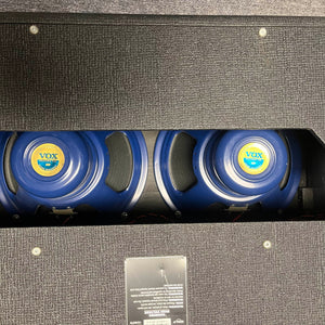 Rear view of a 2004 Vox AC30/6TB guitar amp by Vox, made in England, showing three Celestion Alnico Blues speakers through the open back of the black cabinet.