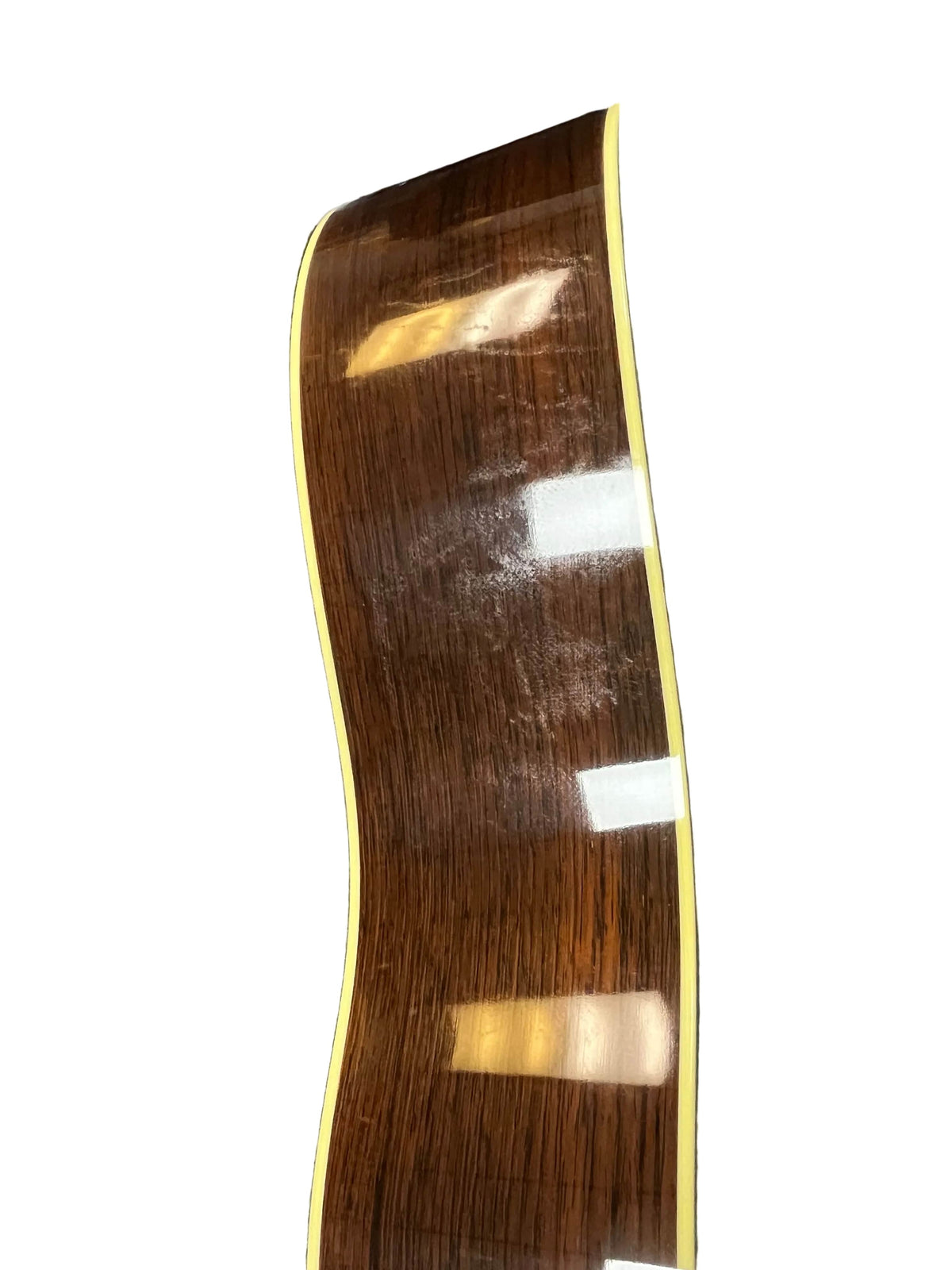 Side view of a 2005 Collings CJ BaA guitar, featuring a polished Brazilian rosewood body, yellow binding, Adirondack spruce top, and reflections of overhead lights.