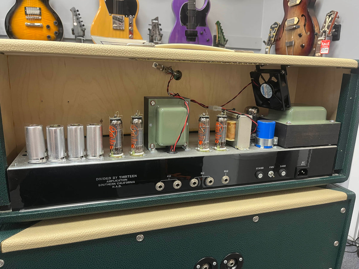 Guitar amplifier with visible components in a music store setting