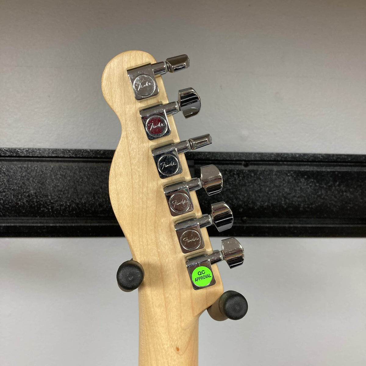 Close-up of the back of a 2007 Fender Standard Telecaster MIM Midnight Wine Red headstock, showing six silver Fender-marked tuning pegs and a "QC APPROVED" green sticker near the bottom, typical for this model.