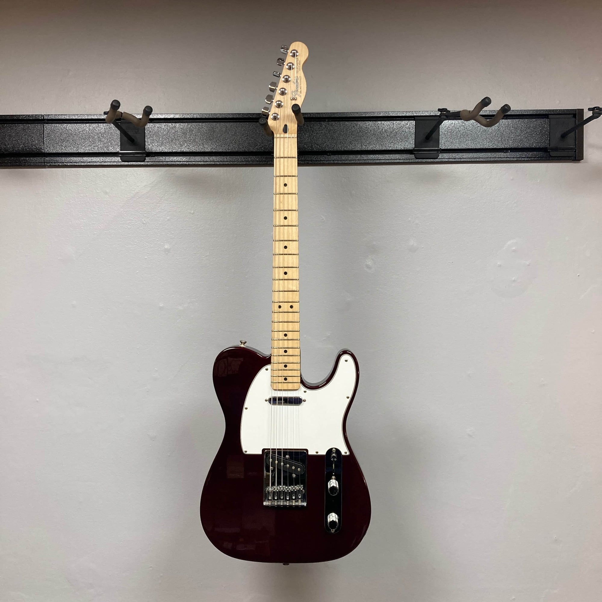 A 2007 Fender Standard Telecaster MIM in Midnight Wine Red with a white pickguard, two single-coil pickups, three knobs, and a maple neck, photographed against a plain light gray wall.