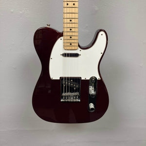 A 2007 Fender Standard Telecaster MIM in Midnight Wine Red with a white pickguard, two single-coil pickups, three knobs, and a maple neck, photographed against a plain light gray wall.