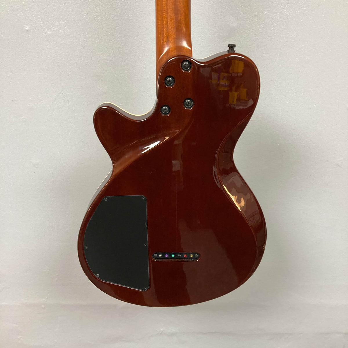 Rear view of a 2009 Godin Summit CT w/Carved Flame Maple Cap electric guitar body by Godin, featuring a black control plate with screws and a row of colored inlays near the lower edge.