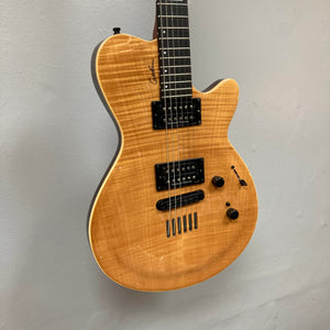 A 2009 Godin Summit CT electric guitar with a carved flame maple cap, natural wood finish, black Seymour Duncan humbuckers, two control knobs, and a signature on the body hangs on a light gray wall.