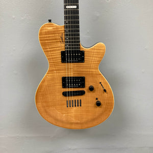 A 2009 Godin Summit CT electric guitar with a carved flame maple cap, Seymour Duncan humbuckers, three knobs, and a toggle switch hangs against a plain gray wall.