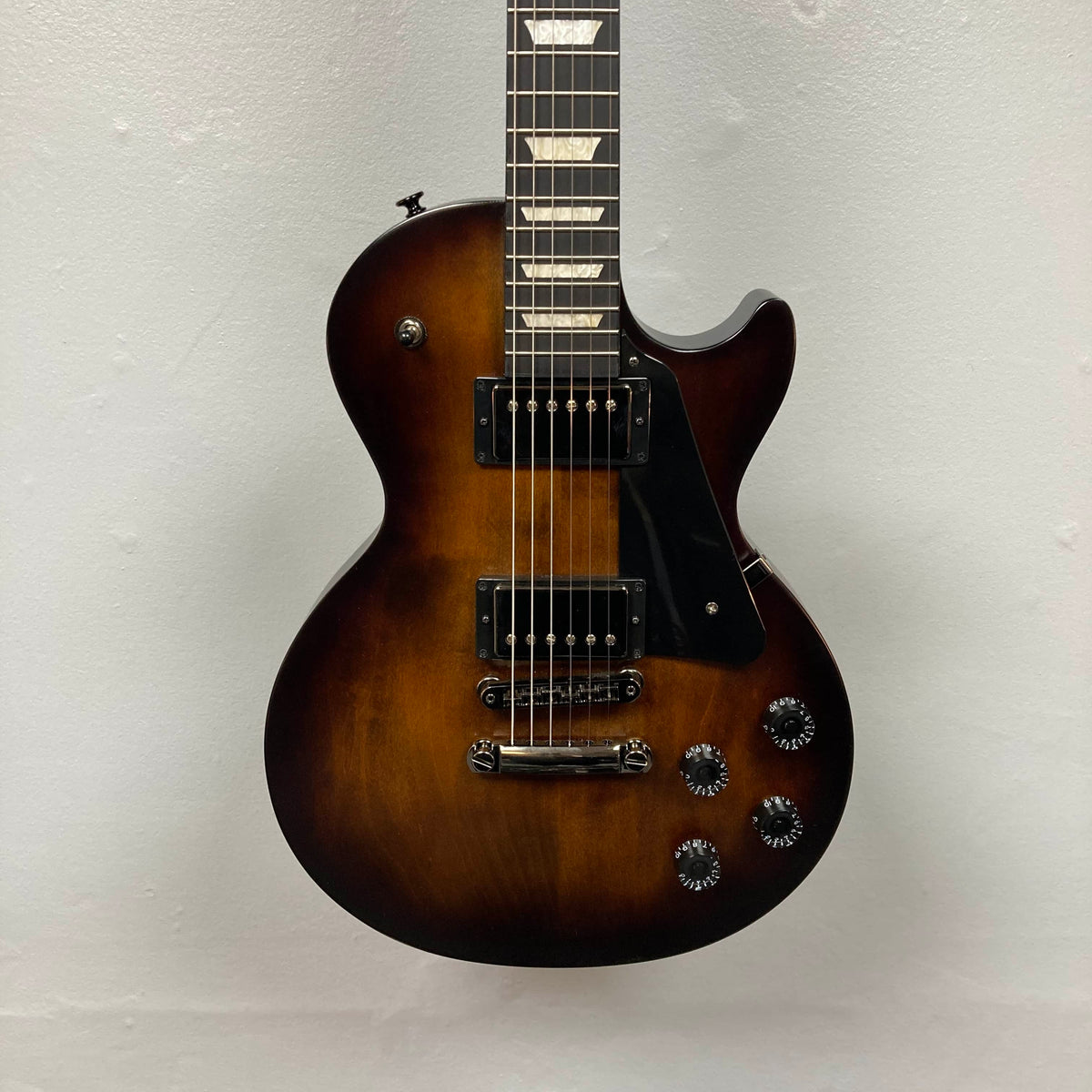 A 2025 Gibson Les Paul Studio Modern in Smokehouse Satin, featuring black pickups, four control knobs, a black pickguard, and photographed against a white background. Includes Gator Molded Case.