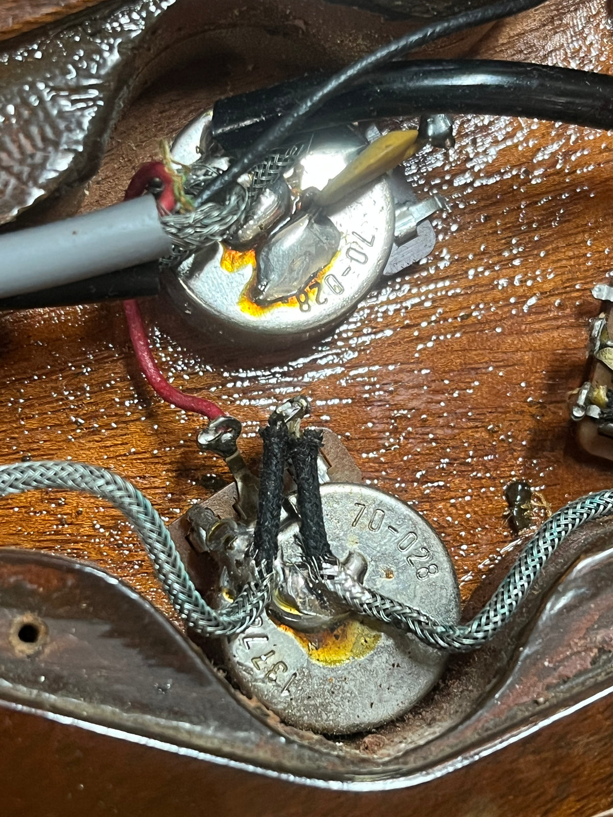 Close-up of two potentiometers with visible wiring and solder joints inside the cavity of a 1978 Gibson EDS-1275 Double Neck Walnut w/Case by Gibson.