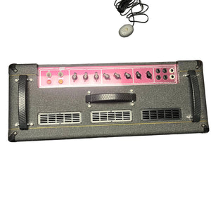 A 2004 Vox AC30/6TB guitar amp head by Vox with a pink control panel, knobs, switches, and coiled power cord displayed on white. Made in England, it pairs iconically with Celestion Alnico Blues speakers.