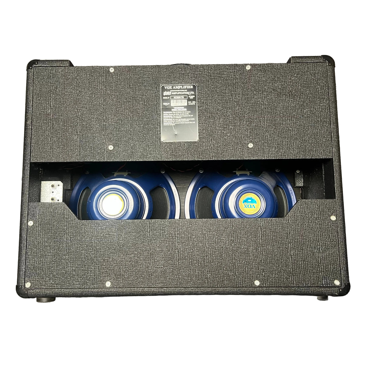 Rear view of a 2004 Vox AC30/6TB amplifier (Made in England) with two Celestion Alnico Blues speakers and a back panel label displaying specifications.