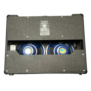 Rear view of a 2004 Vox AC30/6TB amplifier (Made in England) with two Celestion Alnico Blues speakers and a back panel label displaying specifications.