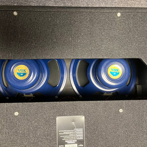 Rear view of a 2004 Vox AC30/6TB guitar amp by Vox, made in England, showing three Celestion Alnico Blues speakers through the open back of the black cabinet.