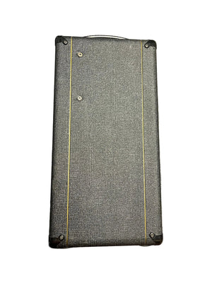 Rectangular black Vox case with textured surface, gold trim, and corner screws—evoking the classic 2004 Vox AC30/6TB (Made in England, Celestion Alnico Blues)—photographed against a white background.