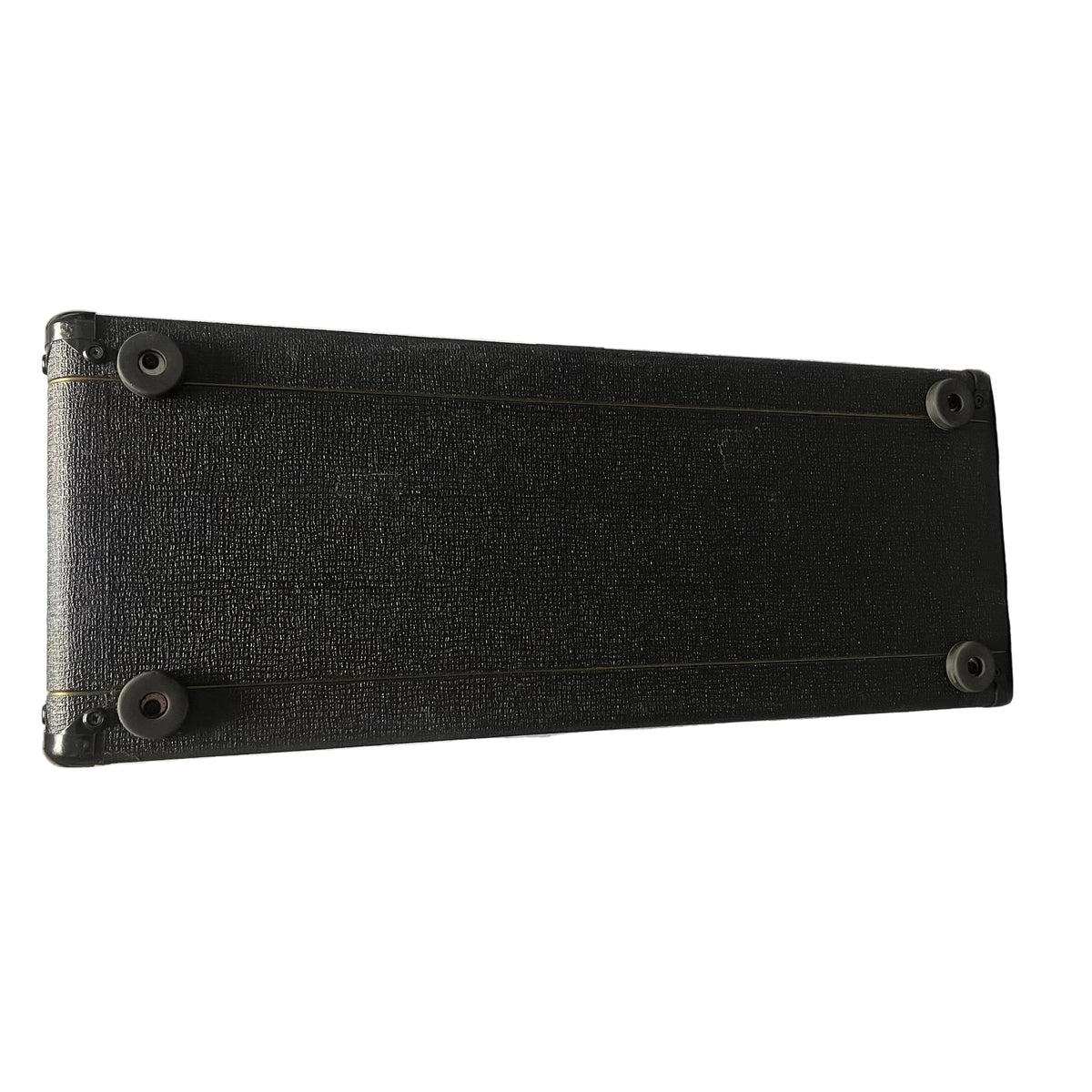 A rectangular black Vox case with textured surface, reinforced corners, and four rubber feet—made in England for the 2004 Vox AC30/6TB with Celestion Alnico Blues.