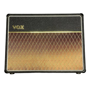 The 2004 Vox AC30/6TB, made in England, features a black control panel, gold VOX logo, brown diamond-pattern grille cloth, and legendary Celestion Alnico Blues speakers.