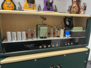 Guitar amplifier with visible components in a music store setting