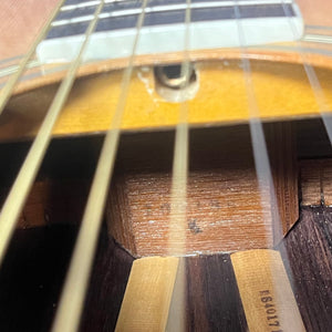 Close-up of the interior of the vintage Sigma DR-35 Acoustic Guitar (Made in Japan), showing strings, wood bracing, and a partial sound hole—echoing its Martin D-35 inspiration. Includes case.