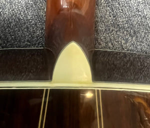 Close-up of the back of a Vintage Sigma DR-35 Acoustic Guitar w/case (Made in Japan) by Sigma, inspired by the Martin D-35, showing neck joint, cream heel cap, and decorative wood binding.