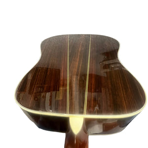 Close-up view of the back of a Japanese-made Sigma DR-35 dreadnought acoustic guitar, showcasing a glossy dark wood finish with light center stripes, inspired by the iconic Martin D-35 design. Includes case.