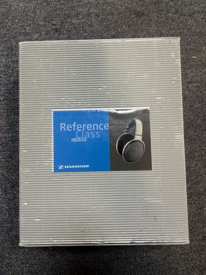 A closed box of Sennheiser HD 650 Reference Class Headphones - Preowned by Sennheiser is displayed on a gray carpeted surface.