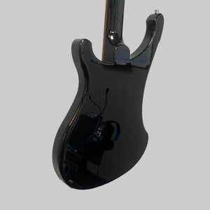 A black electric guitar is mounted on a white wall next to a red electric guitar, while a vintage bass guitar—like the Rickenbacker 4003 Bass Guitar – 2020 Jetglo w/Case by Rickenbacker—completes the striking display.