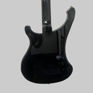 Mounted on a white wall, the sleek black Rickenbacker 4003 Bass Guitar – 2020 Jetglo w/Case reflects a person and objects in the room. Its lustrous finish and signature curves capture the timeless allure of this iconic Rickenbacker bass.