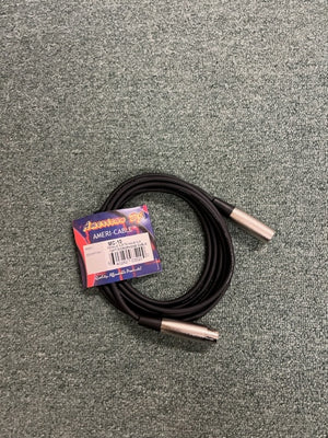 A coiled American DJ MC-10 10ft XLR microphone cable with silver connectors and its label attached lies on a gray carpeted surface.