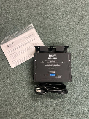 A black Elation Professional DP-415 4-Channel Dimmer/Power Pack is shown on a gray carpet with a power cord and manual, ideal for DMX-compatible stage lighting control.