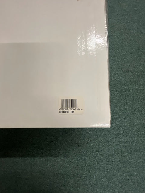 A white rectangular Monster Power PRO 7000 Professional Reference PowerSource by Monster Power with a barcode sticker in the lower right corner, placed on a green textured surface.