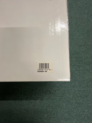 A white rectangular Monster Power PRO 7000 Professional Reference PowerSource by Monster Power with a barcode sticker in the lower right corner, placed on a green textured surface.