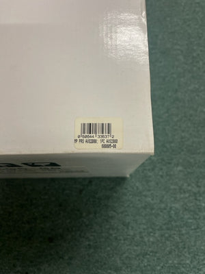 A close-up of a white box with a barcode sticker labeled “HP PRO AWS2000, PRC AWS2000, 600065-00,” possibly for the Monster Power AVS 2000 PRO Professional Reference Automatic Voltage Stabilizer by Monster Power, on a green surface.