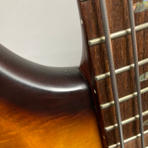 Close-up of the Ibanez SDGR SR500PB w/Hard case by Ibanez, highlighting the neck-body joint, four flatwound strings, a wooden fretboard with inlay, and a vibrant sunburst body finish.