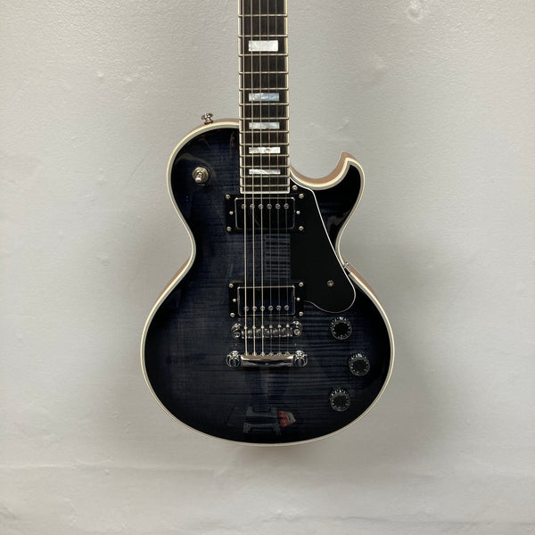 A used Schecter Solo-II Custom electric guitar in Trans Black Burst finish with chrome hardware and Pasadena pickups, displayed against a light gray wall; includes case.