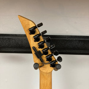 The image shows the back of a 1992 Carvin Ultra V USA electric guitar headstock, featuring six black tuners and a locking nut on a light wood neck. This model includes a Kahler Steeler Trem and MJ-wound Seymour Duncan DCJ pickups.