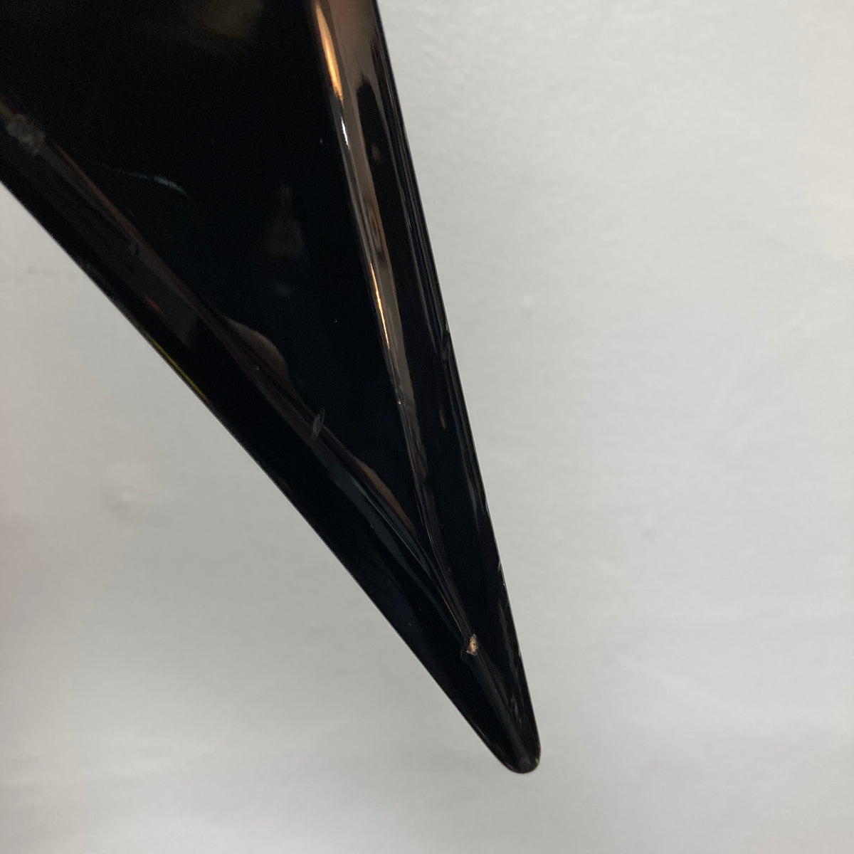 Close-up of a glossy black 1992 Carvin Ultra V USA with Kahler Steeler Trem and MJ‑wound Seymour Duncan DCJ, showing a small chip near the tip against a plain white background.