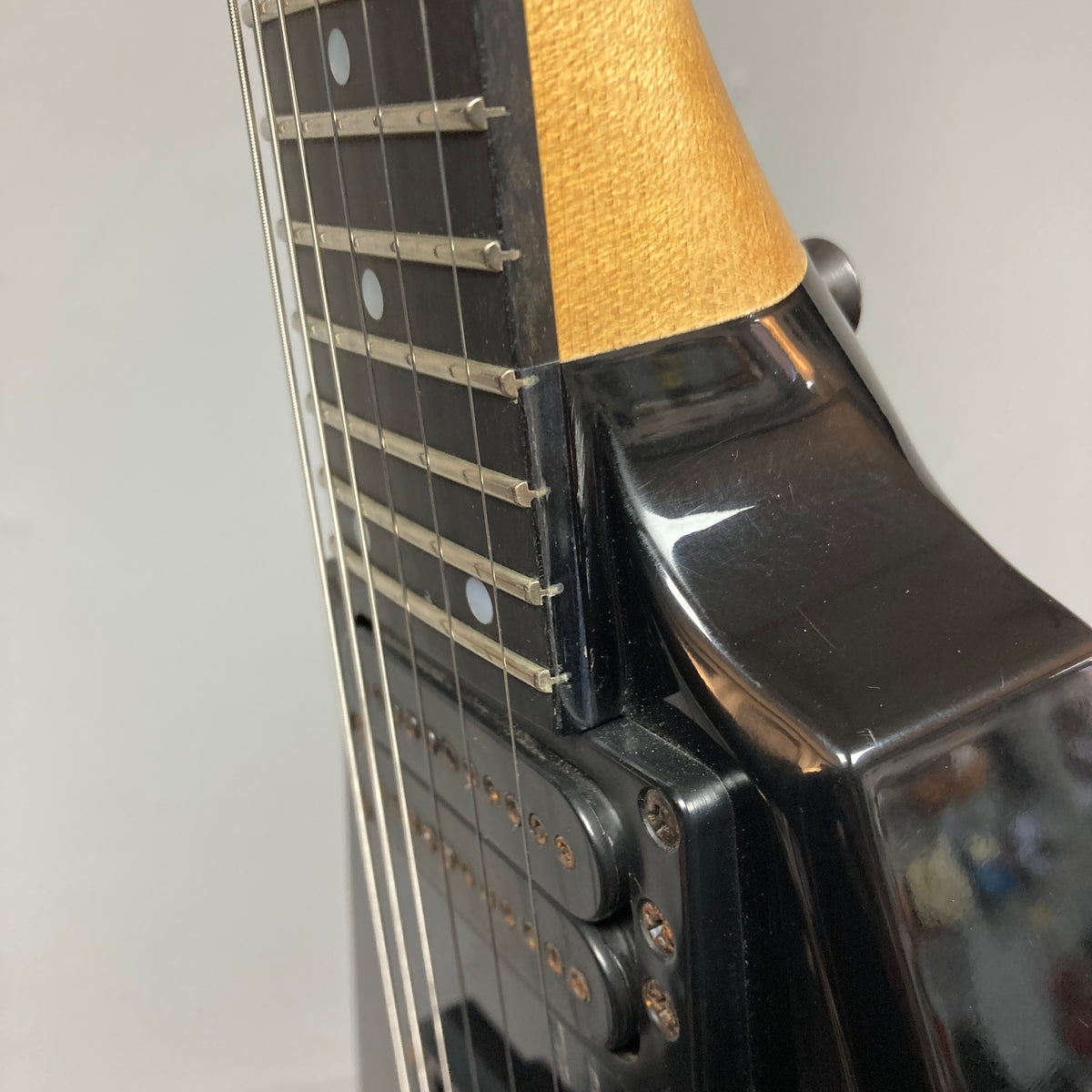 Close-up view of a Carvin 1992 Ultra V USA electric guitar neck and body, featuring strings, frets, and pickups with a Kahler Steeler Trem and MJ-wound Seymour Duncan DCJ.