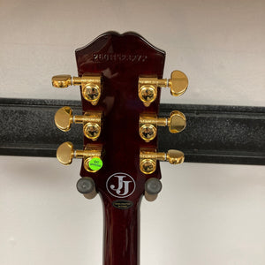 The back of the Epiphone Jerry Cantrell Wino Les Paul Custom in Wine Red features six gold tuners, manufacturer stickers, and a visible serial number on a rich wood grain finish.