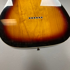 Close-up of the lower body of a sunburst acoustic guitar, highlighting exposed bridge pin holes—echoing classic details of the Fender Heritage '60s Telecaster Custom Made in Japan Sunburst w/Gigbag Consign by Fender.