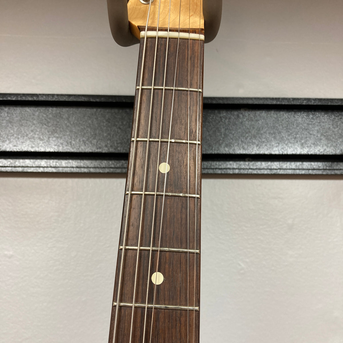 Close-up of the Fender Heritage '60s Telecaster Custom Made in Japan Sunburst w/Gigbag, showing six strings, frets, and two dot inlays on its rosewood fingerboard against a plain background.