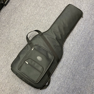 A black soft gigbag, ideal for the Fender Heritage '60s Telecaster Custom Made in Japan Sunburst, sits on a gray carpet and features a front zipper pocket.