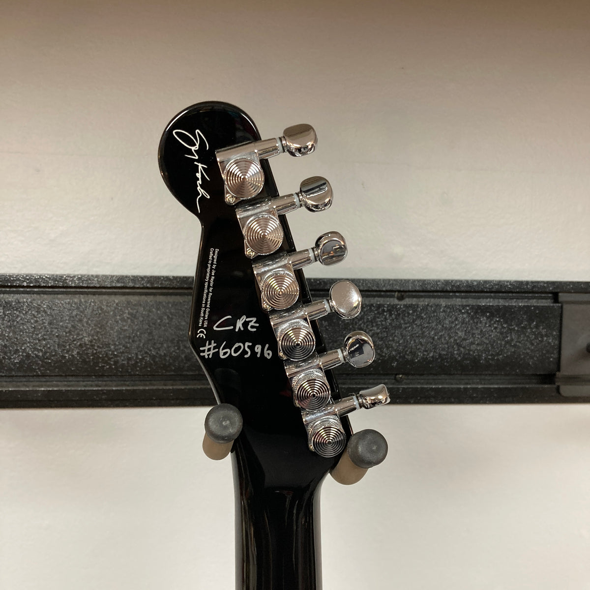 Close-up of the back of a Reverend Greg Koch Signature Gristle 90 headstock in 3-Tone Burst, showing six tuning pegs, a signature, and the markings "CR2 #60596" in white.