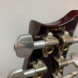 Close-up of the headstock on a PRS Custom 24 Violet 2011 electric guitar by PRS, serial number 11 176923, highlighting damaged wood near one tuning machine.