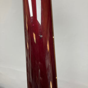 Close-up of a glossy violet surface, likely the body of a PRS Custom 24 Violet 2011 electric guitar by PRS, with a visible chip or dent near the center, set against a plain light background.