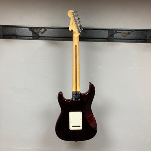 A Fender American Standard Strat upgraded Gilmour EMG DC-20 electric guitar in striking Bordeaux Metallic is displayed hanging on a wall mount, shown from the back with the headstock at the top and the body at the bottom. This model features EMG pickups for that iconic David Gilmour tone.