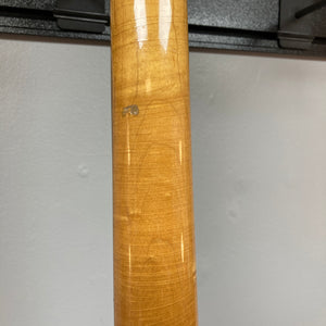 Close-up of the wooden neck of a 1966 Ampeg ASB-1 Devil Bass (Serial #531), showcasing pronounced grain patterns, minor scratches, and a small ding—details that highlight its vintage character—set against a plain light gray wall.