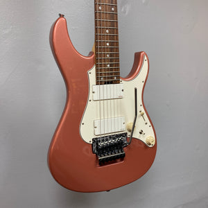 Featuring a metallic burgundy mist finish, white pickguard, dual humbucker pickups, and a tremolo bridge, this eye-catching seven-string electric guitar hanging on a plain light gray wall is the Edwards E-SN7-194MF Mikio Fujioka Signature by Edwards.